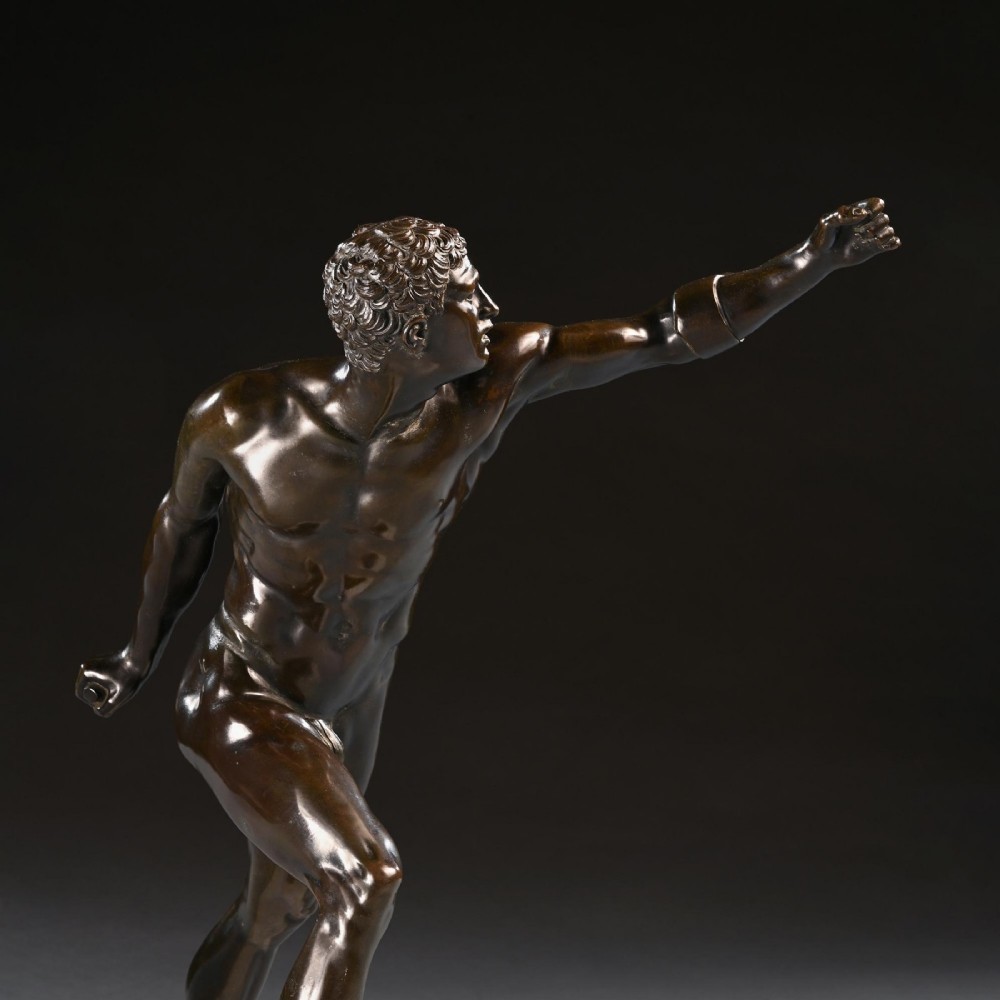 A 19th-century patinated bronze sculpture depicting the Borghese Gladiator in a dynamic lunging pose, mounted on a light-coloured marble base. View VII