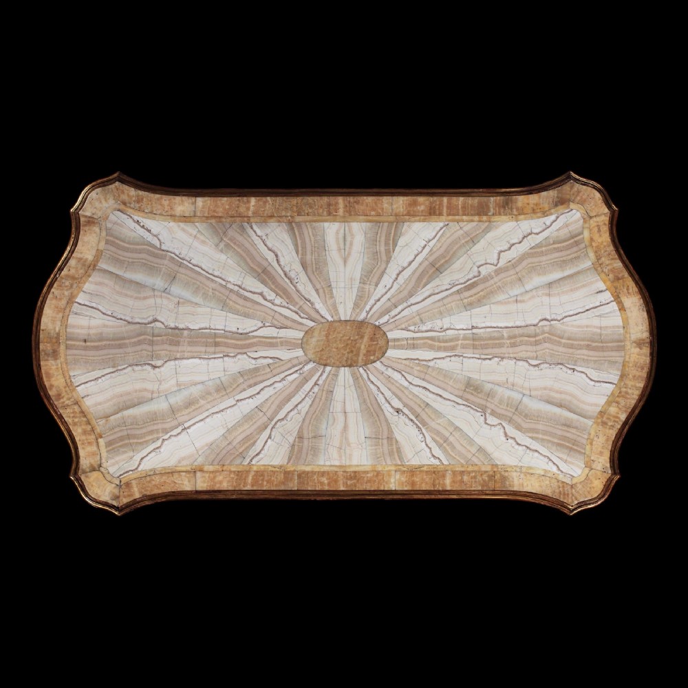 An ornate Italian centre table featuring a sunburst pattern onyx top supported by a sculpted polychrome and gilded wooden frame shaped like grapevine branches. View IX