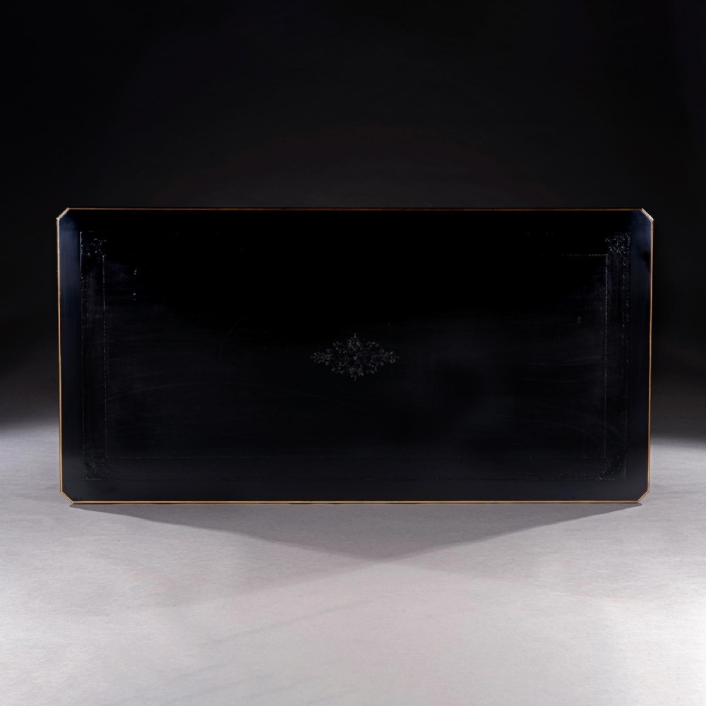 A late nineteenth-century French ebonised writing desk featuring gilt mouldings, three frieze drawers, and slender fluted tapered legs. View VII