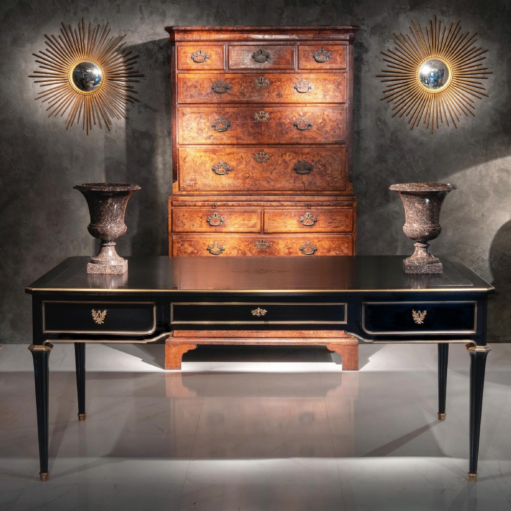 A late nineteenth-century French ebonised writing desk featuring gilt mouldings, three frieze drawers, and slender fluted tapered legs. View VIII