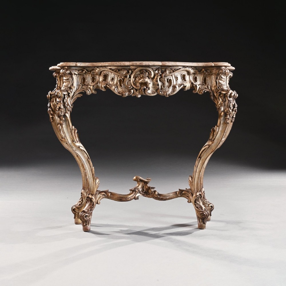 A 19th-century Italian silver gilt console table featuring elaborate Rococo carvings, cabriole legs, a central stretcher, and a contoured marble top. View II