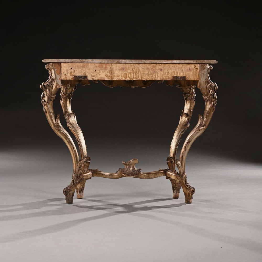 A 19th-century Italian silver gilt console table featuring elaborate Rococo carvings, cabriole legs, a central stretcher, and a contoured marble top. View V