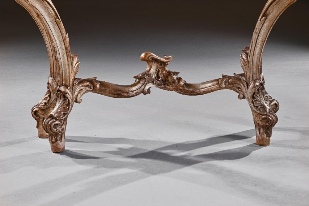 A 19th-century Italian silver gilt console table featuring elaborate Rococo carvings, cabriole legs, a central stretcher, and a contoured marble top. View VII