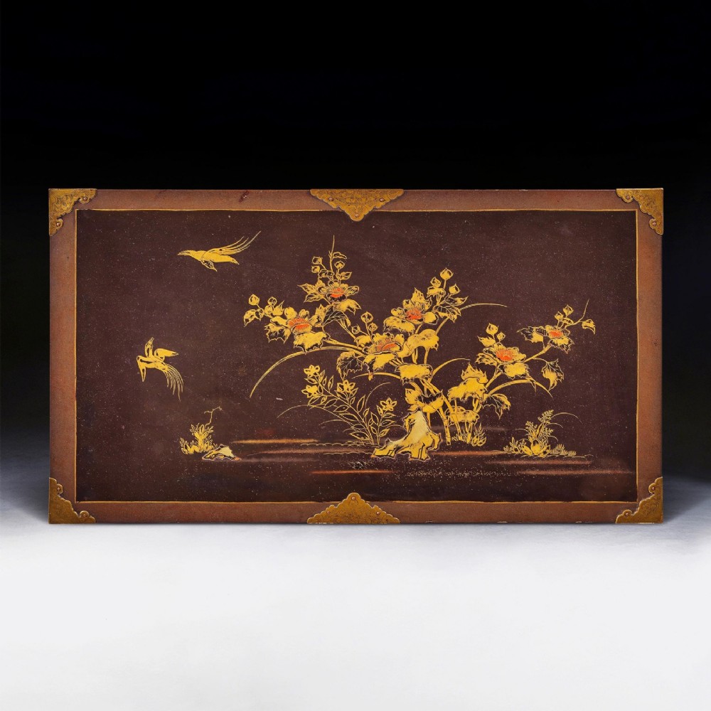 A black Japanese urushi lacquer cabinet decorated with gold landscape scenes and metal corner mounts, supported on a carved French Regence giltwood stand with cabriole legs. View IX