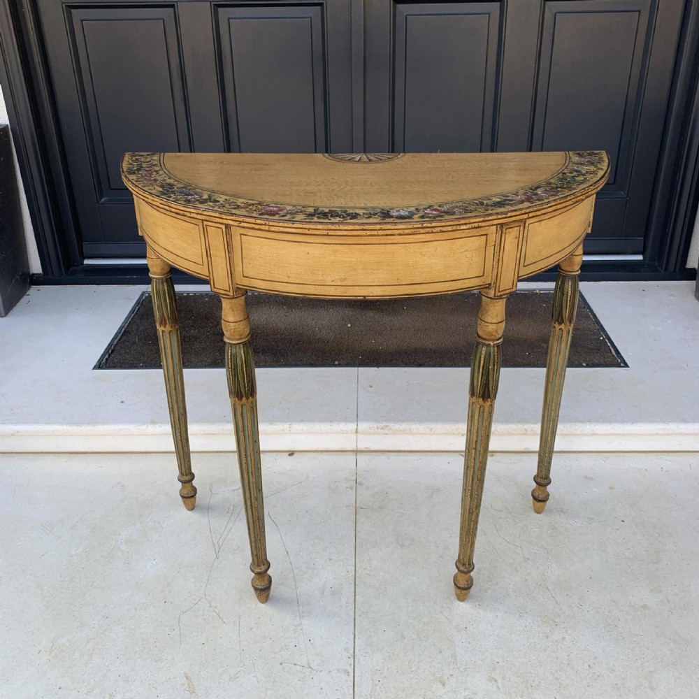 A Georgian painted demi-lune pier table featuring a semi-circular top with polychrome painted borders and four fluted tapered legs. View VI