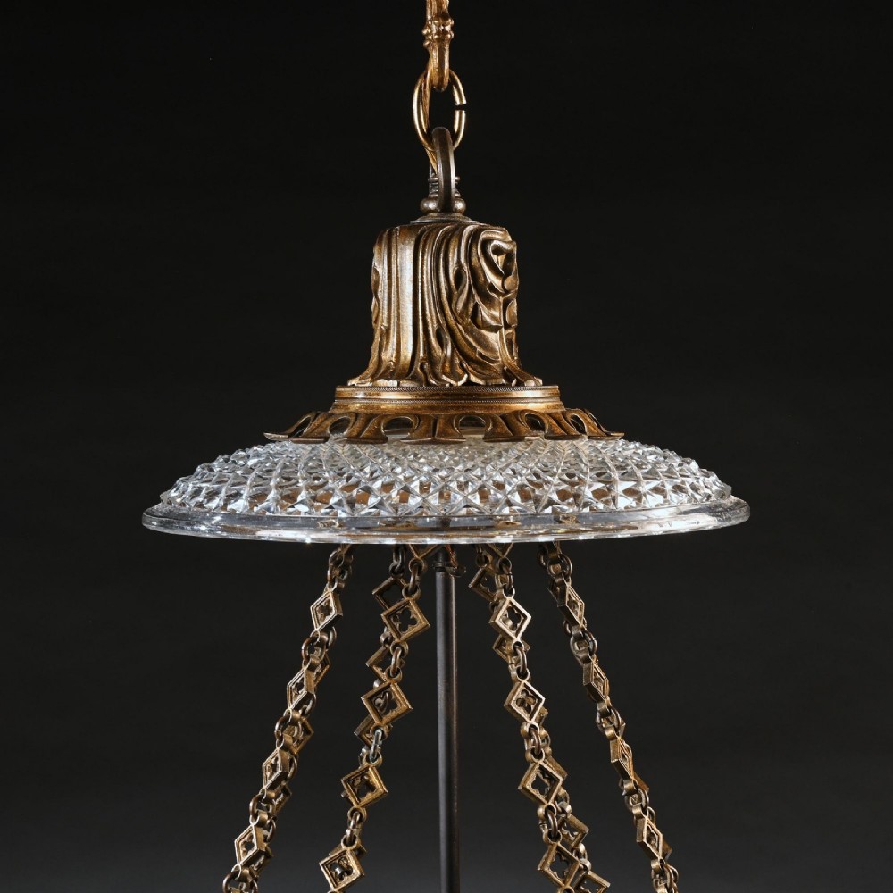 A Regency gilt brass hall lantern featuring Gothic tracery arches, glass side panels, an upper cut-glass shade, and a hanging chain. View IV