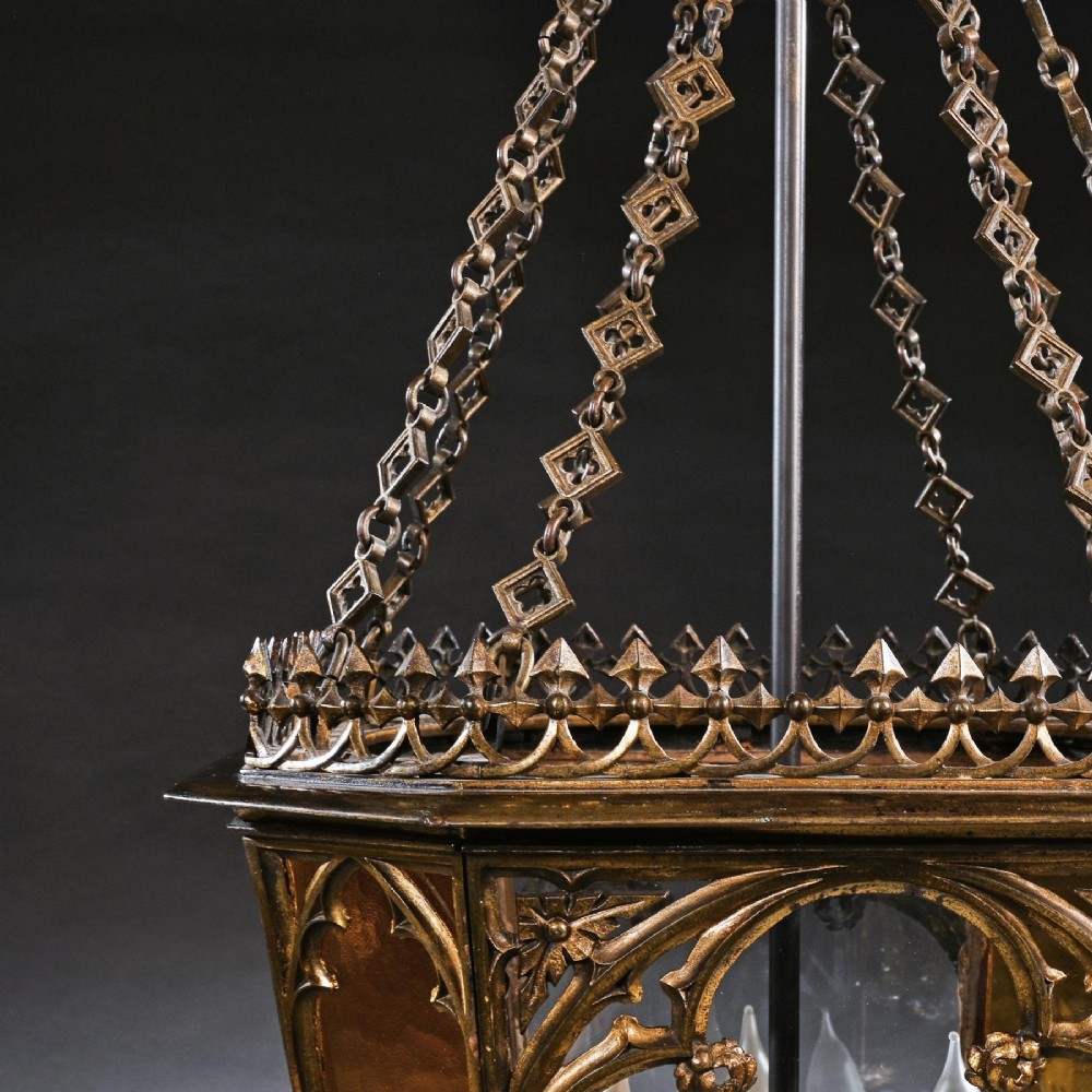 A Regency gilt brass hall lantern featuring Gothic tracery arches, glass side panels, an upper cut-glass shade, and a hanging chain. View V