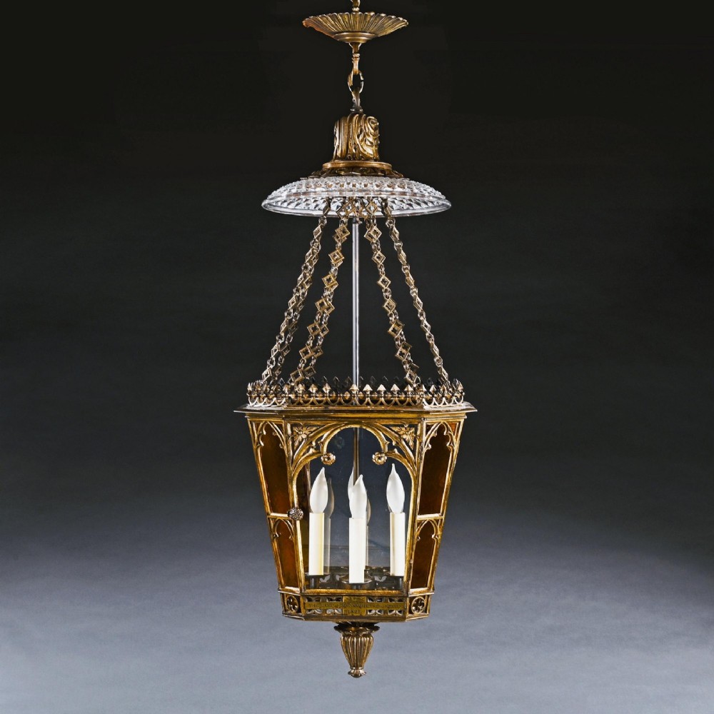 A Regency gilt brass hall lantern featuring Gothic tracery arches, glass side panels, an upper cut-glass shade, and a hanging chain. View VI