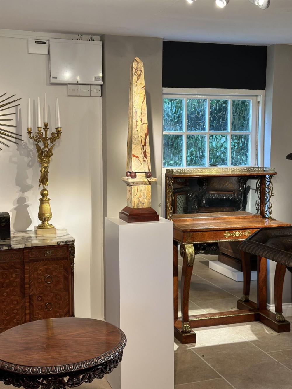 A pair of tall, veined marble obelisks carved from Portasanta and Rosso Antico marble with polished spherical details on tiered square bases. View XII