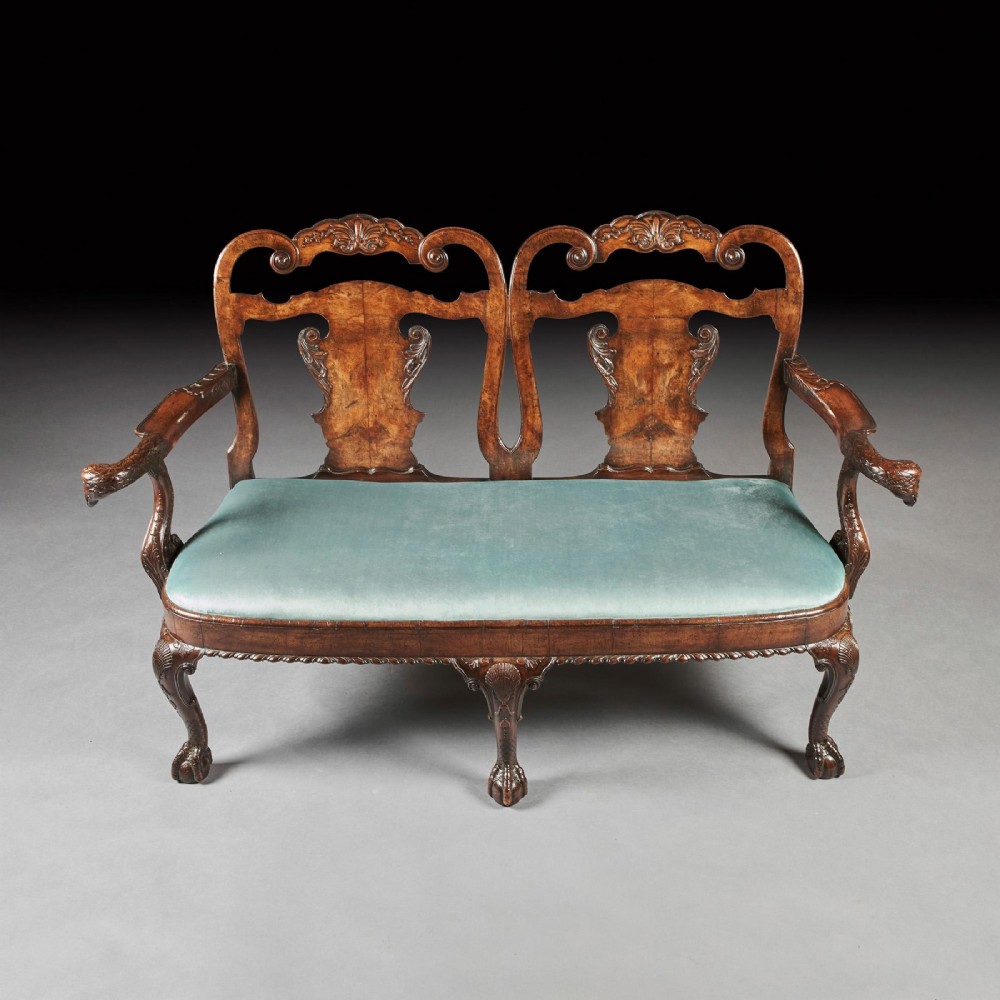 A late nineteenth-century walnut twin chair back sofa featuring vasiform splats, shell carving, cabriole legs with claw and ball feet, and a teal upholstered seat. View II
