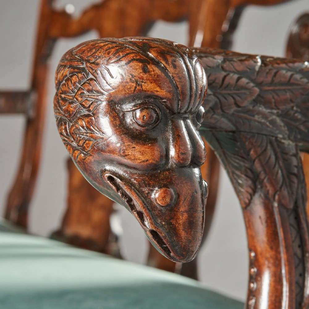 A late nineteenth-century walnut twin chair back sofa featuring vasiform splats, shell carving, cabriole legs with claw and ball feet, and a teal upholstered seat. View V