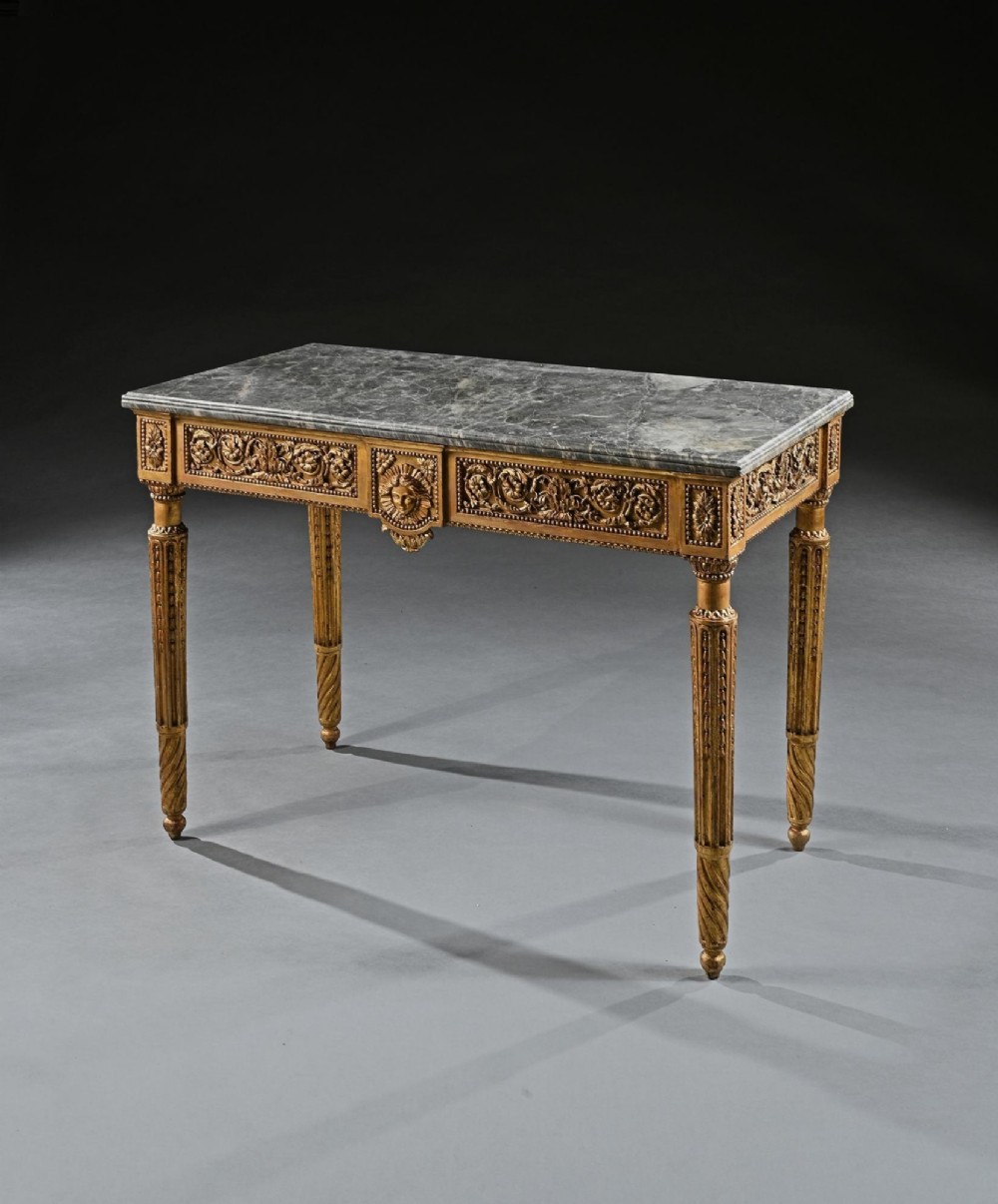An 18th-century Italian Neoclassical console table featuring a grey veined marble top, an intricate giltwood frieze with a central carved mask, and fluted legs. View III