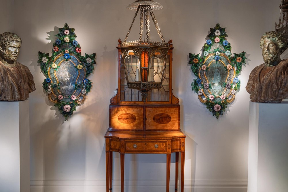 A pair of 18th-century Venetian Murano glass wall mirrors featuring decorative glass foliage, colourful glass flowers, etched central mirror plates, and gilt accents. View VI