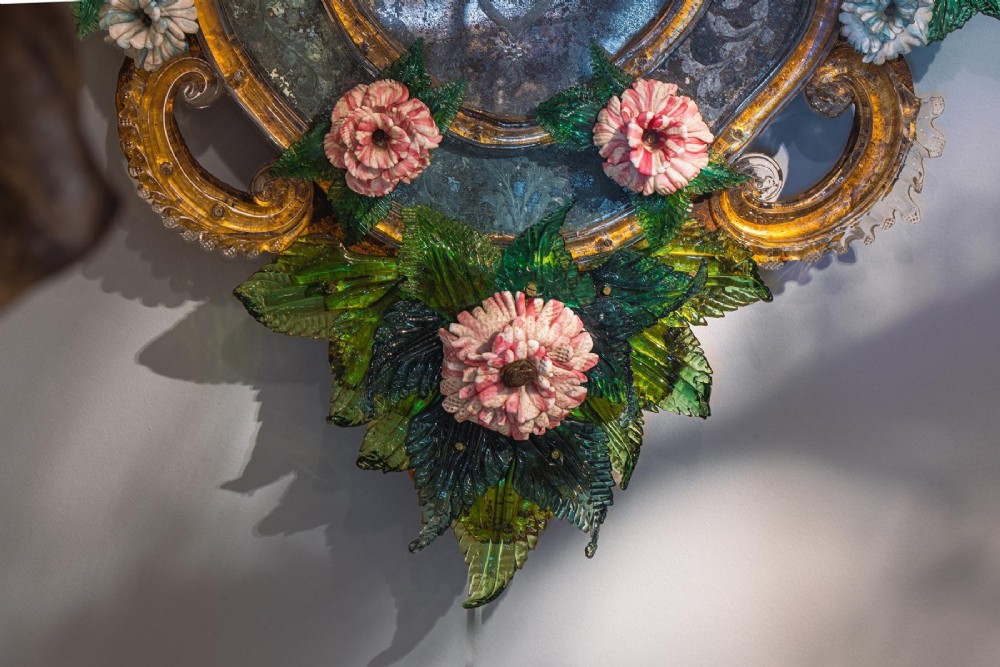 A pair of 18th-century Venetian Murano glass wall mirrors featuring decorative glass foliage, colourful glass flowers, etched central mirror plates, and gilt accents. View IX