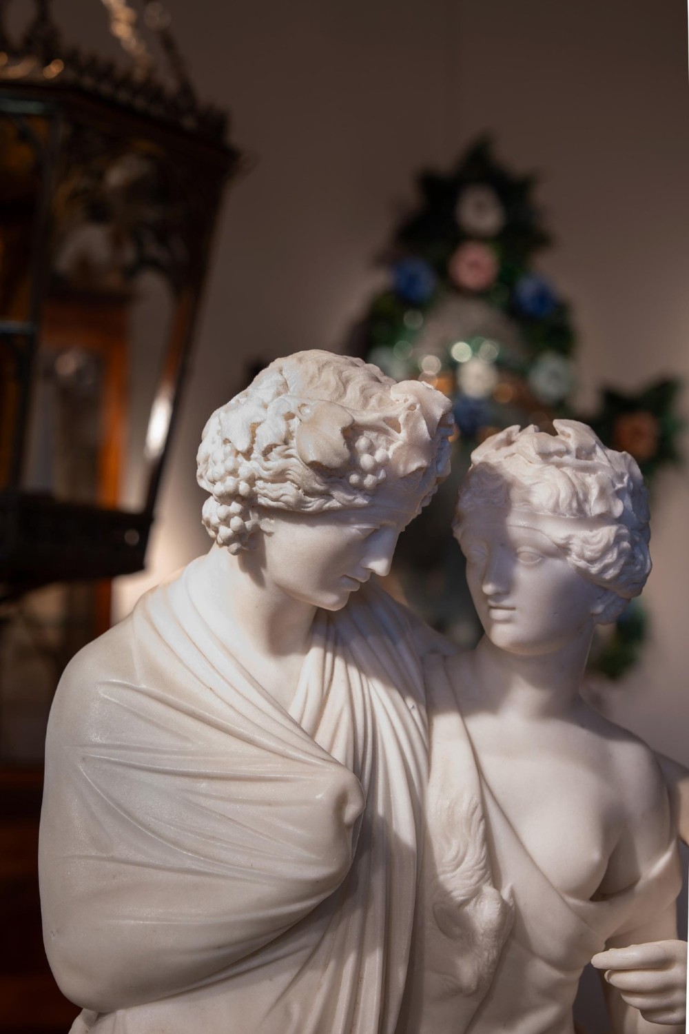 A hand-carved white marble Neoclassical sculpture depicting the classical mythological figures of Bacchus and Ariadne standing together on a circular integral base. View VIII
