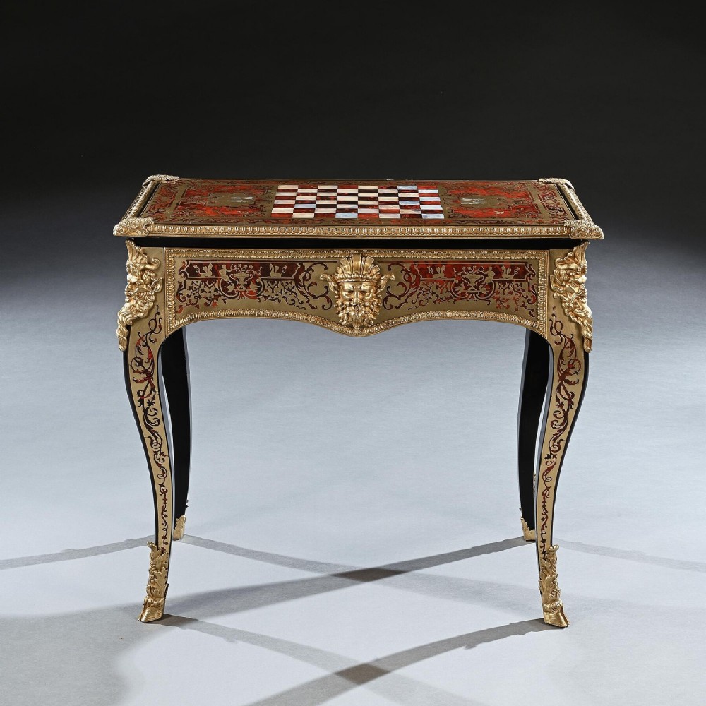 A George IV period Boulle marquetry games table featuring brass and tortoiseshell inlay, gilt-bronze mounts, cabriole legs, and an inlaid chessboard top.