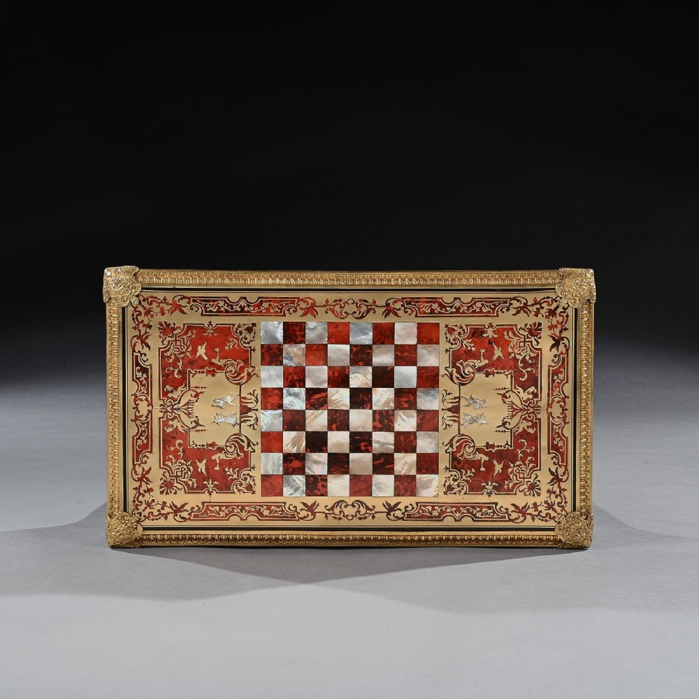 A George IV period Boulle marquetry games table featuring brass and tortoiseshell inlay, gilt-bronze mounts, cabriole legs, and an inlaid chessboard top. View XII