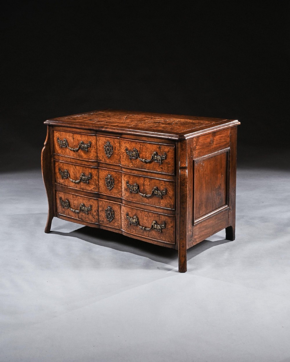 An 18th-century French Louis XV provincial commode made from figured burr elm with three drawers and cast brass handles. View VII