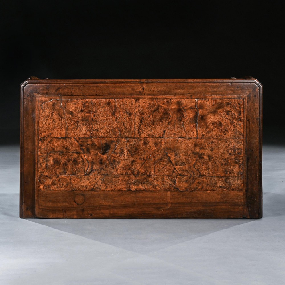 An 18th-century French Louis XV provincial commode made from figured burr elm with three drawers and cast brass handles. View X