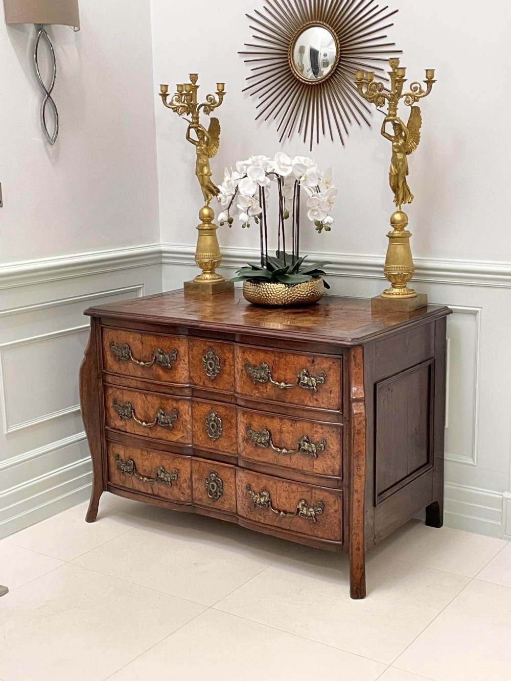 An 18th-century French Louis XV provincial commode made from figured burr elm with three drawers and cast brass handles. View XI