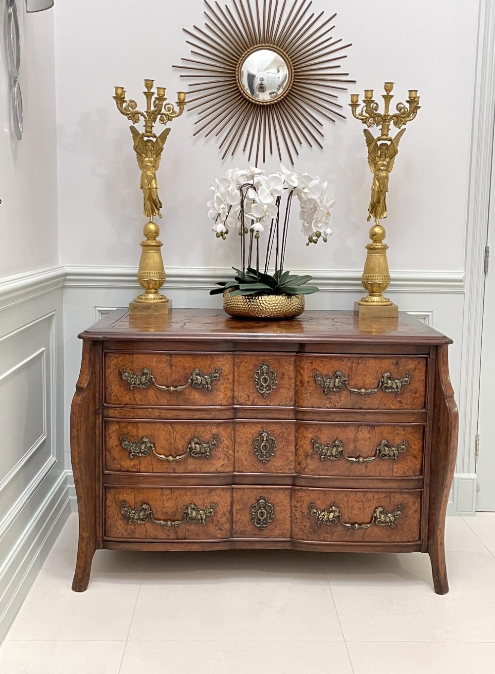 An 18th-century French Louis XV provincial commode made from figured burr elm with three drawers and cast brass handles. View XII