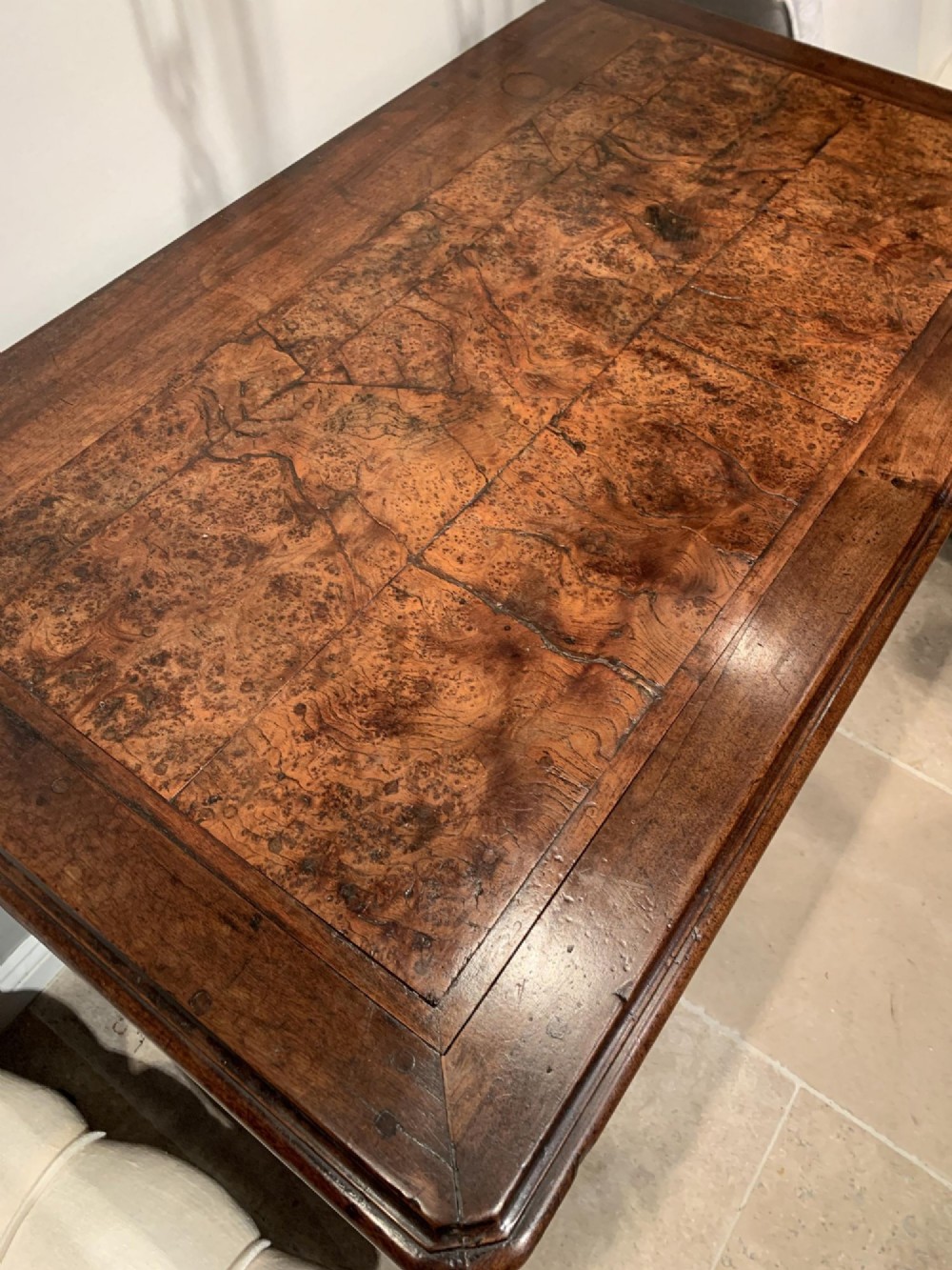 An 18th-century French Louis XV provincial commode made from figured burr elm with three drawers and cast brass handles. View XIII