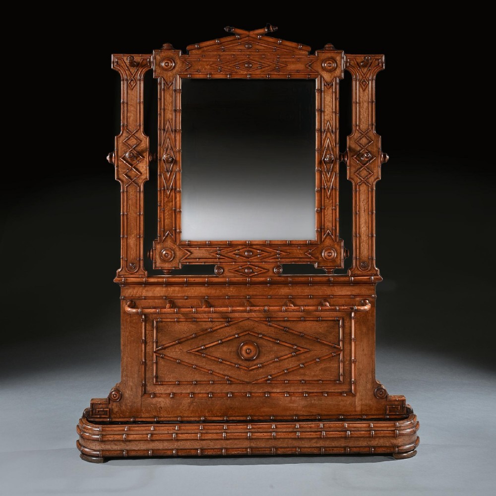 A late 19th-century French Aesthetic Period hall stand made from birdseye maple featuring turned faux bamboo detailing, a central rectangular mirror, coat hooks, geometric carved panelling, and an umbrella rack base. View III