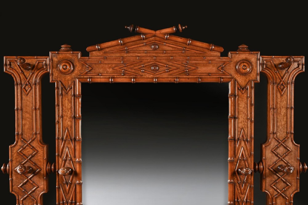 A late 19th-century French Aesthetic Period hall stand made from birdseye maple featuring turned faux bamboo detailing, a central rectangular mirror, coat hooks, geometric carved panelling, and an umbrella rack base. View IV
