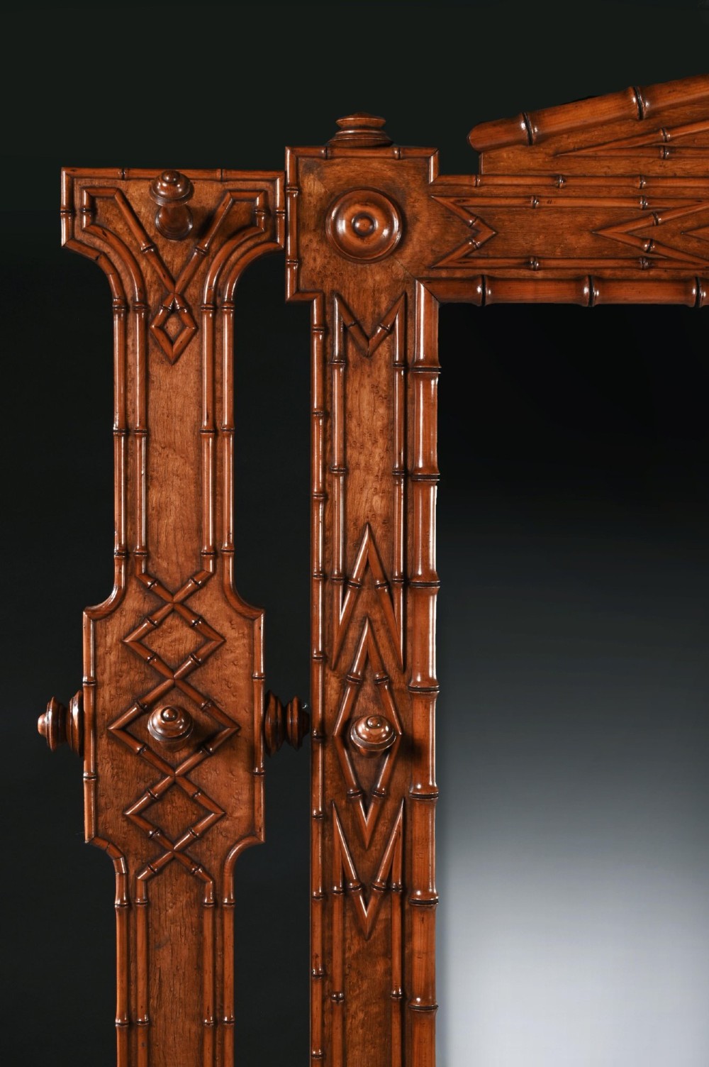A late 19th-century French Aesthetic Period hall stand made from birdseye maple featuring turned faux bamboo detailing, a central rectangular mirror, coat hooks, geometric carved panelling, and an umbrella rack base. View V