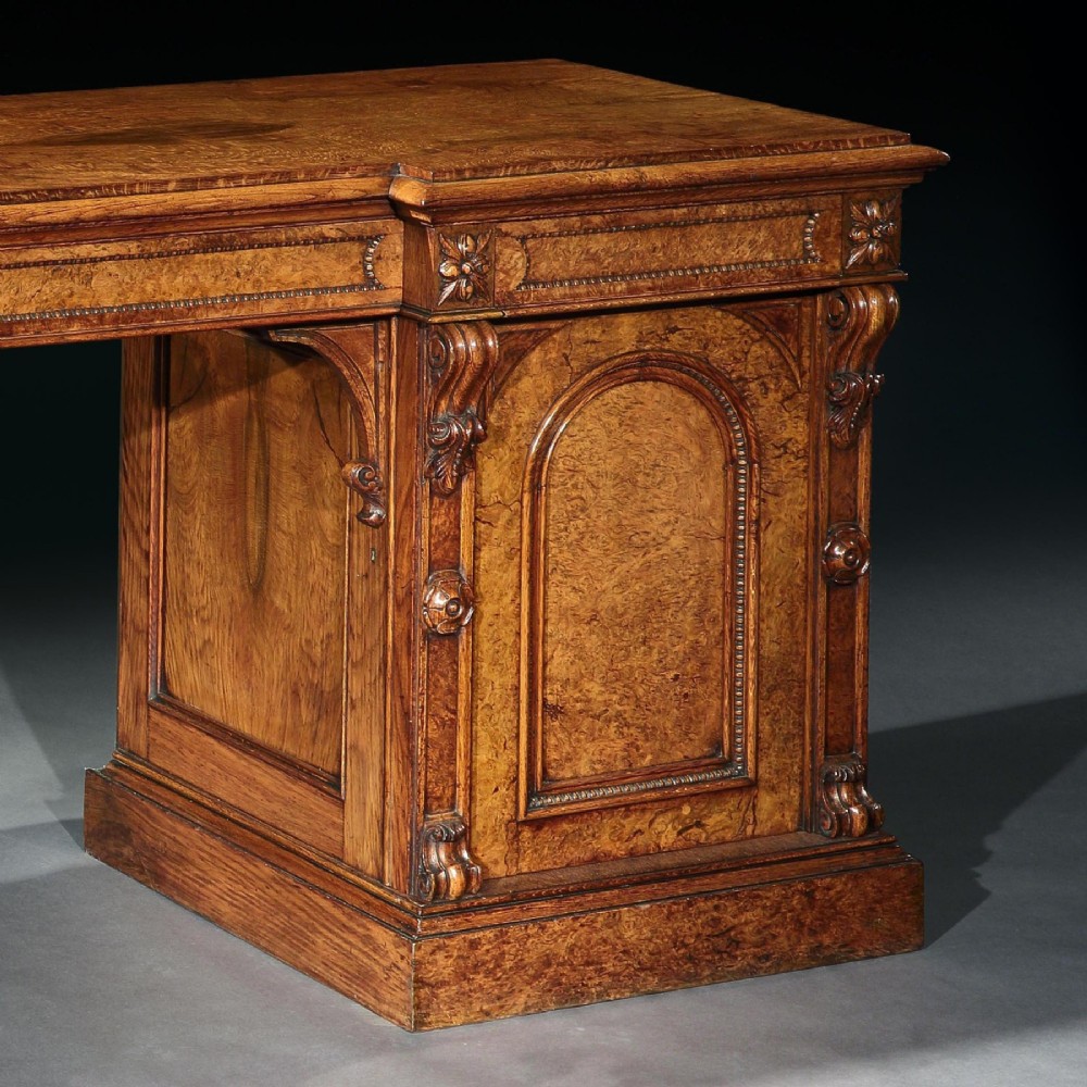 A mid-19th century Victorian pollard oak pedestal sideboard featuring arched panelled doors, carved corbels, and figured wood grain. View III