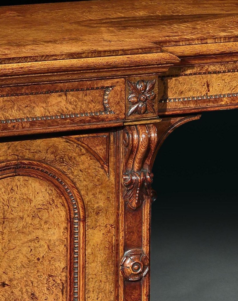 A mid-19th century Victorian pollard oak pedestal sideboard featuring arched panelled doors, carved corbels, and figured wood grain. View IV