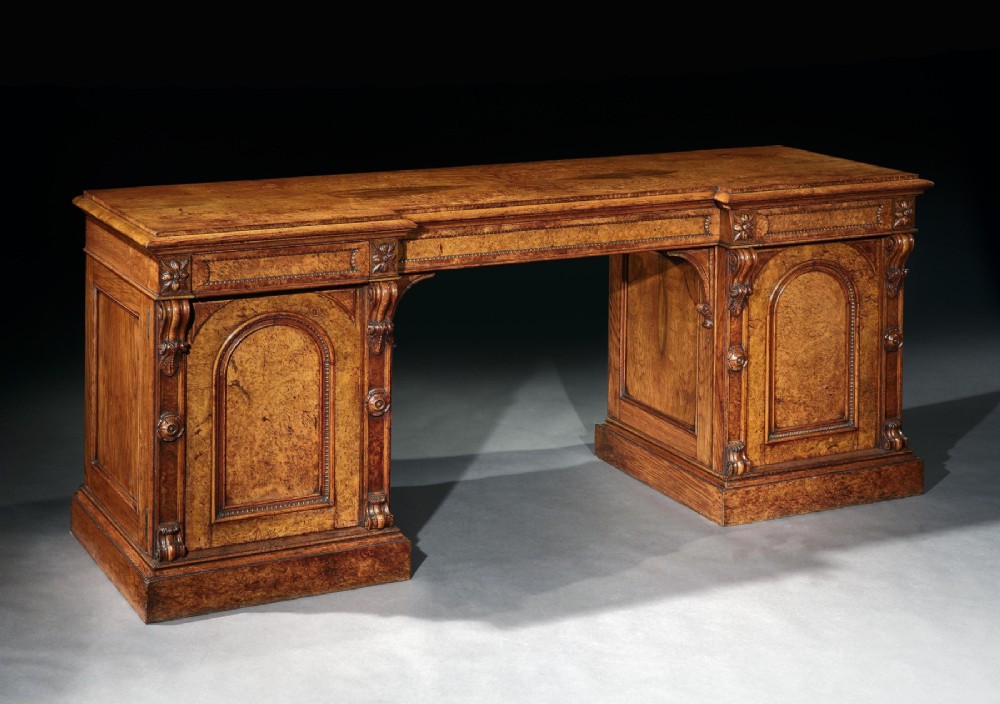 A mid-19th century Victorian pollard oak pedestal sideboard featuring arched panelled doors, carved corbels, and figured wood grain. View V
