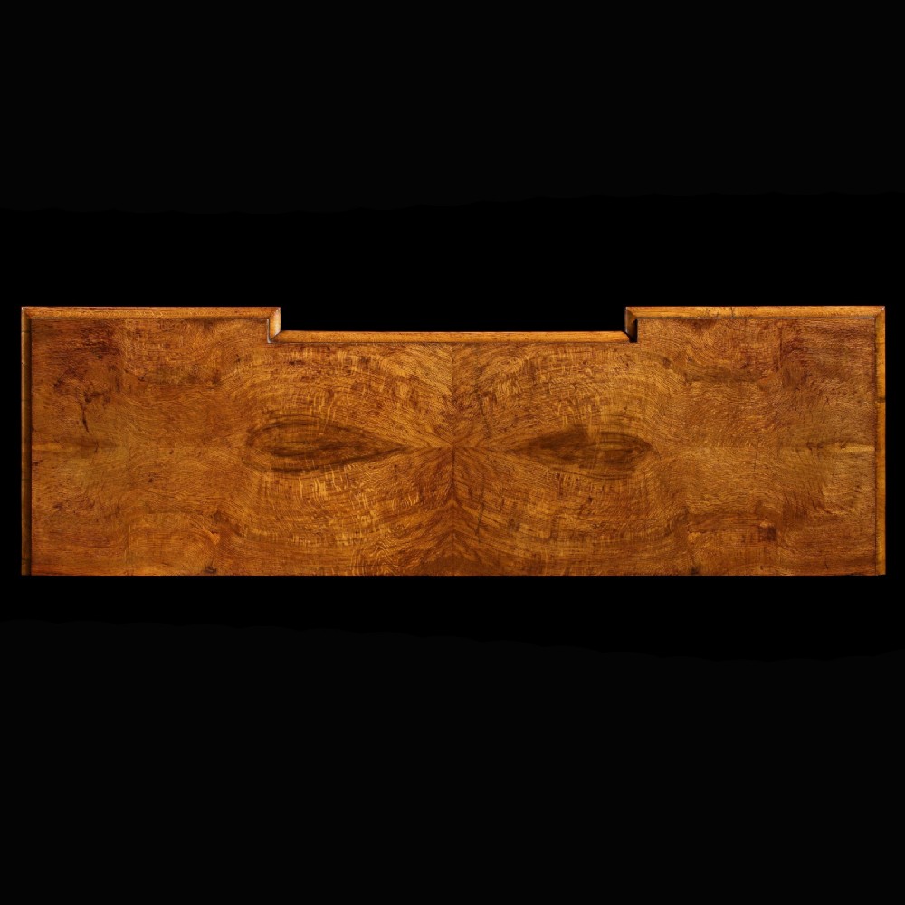 A mid-19th century Victorian pollard oak pedestal sideboard featuring arched panelled doors, carved corbels, and figured wood grain. View VI