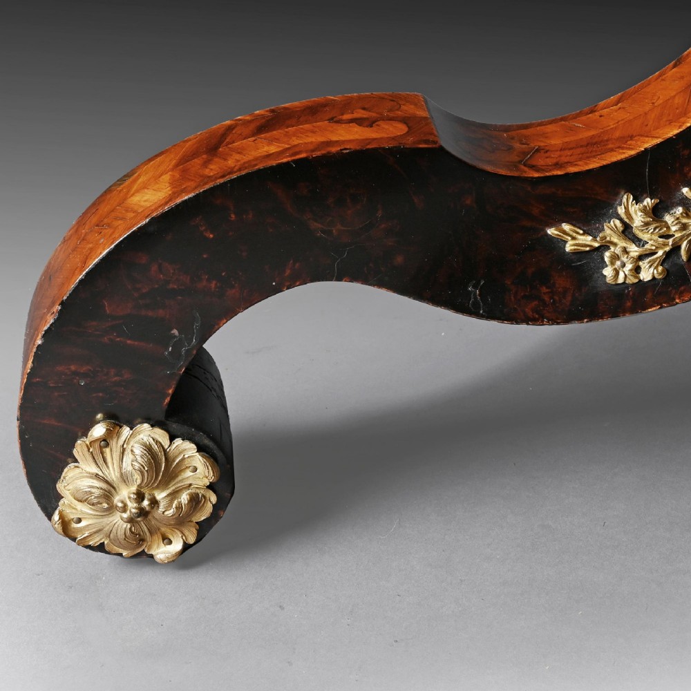 A 19th-century circular marquetry centre table featuring floral wood inlays, a tilt-top mechanism, and a dark carved tripod base with gilt-bronze mounts. View VIII