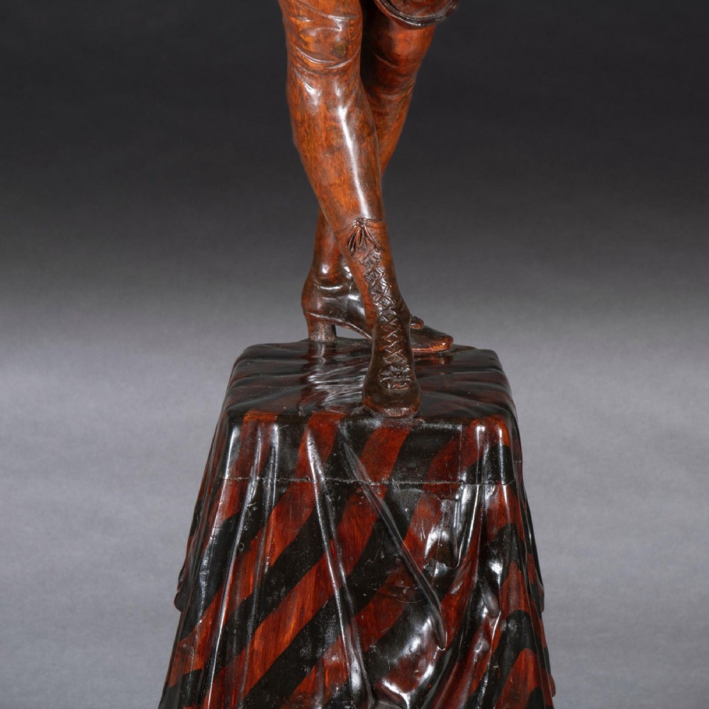 A pair of carved brown wood figures depicting Renaissance figures atop detailed wooden bases. View VII
