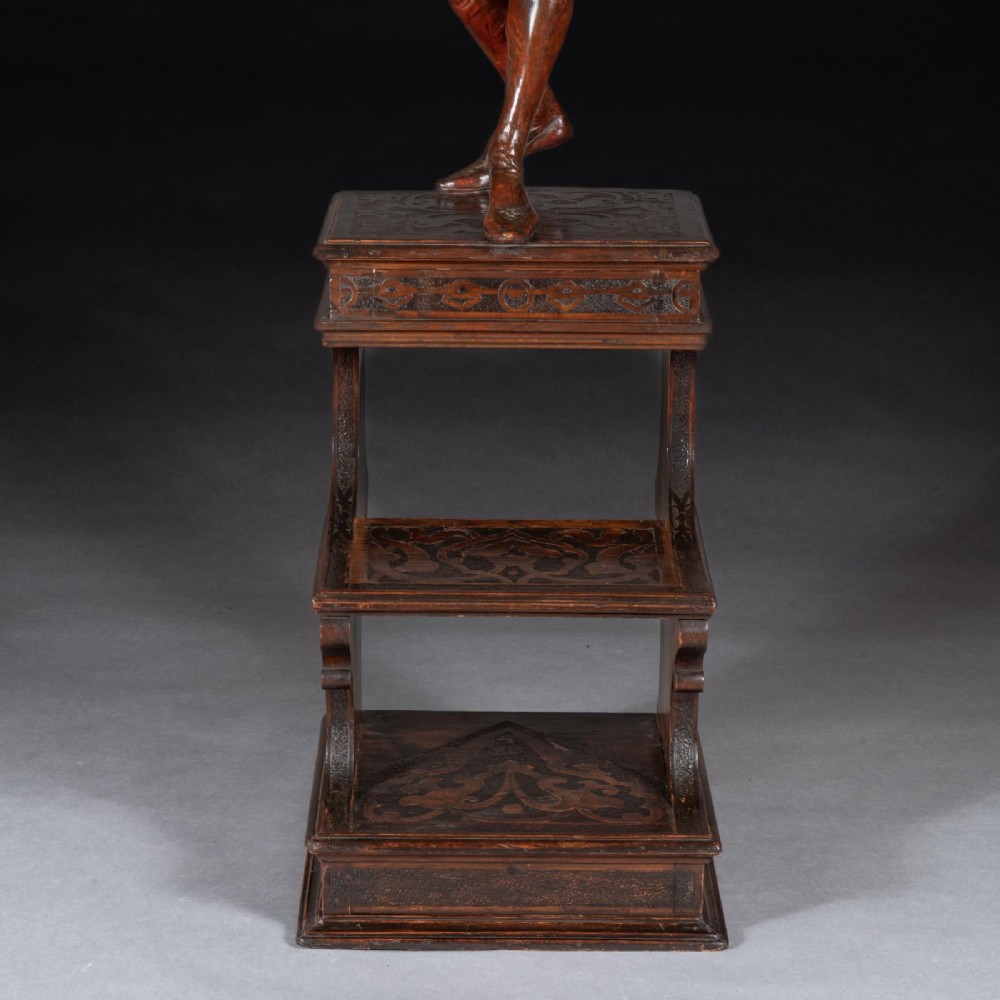A pair of carved brown wood figures depicting Renaissance figures atop detailed wooden bases. View XIII