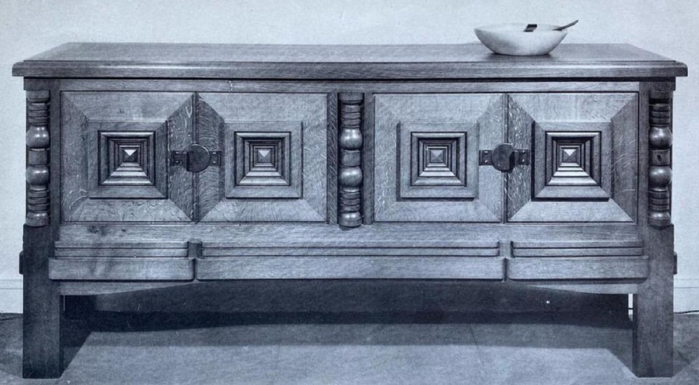Mid-twentieth-century French oak sideboard featuring four cabinet doors with raised geometric diamond panels and turned wooden column accents. View VIII