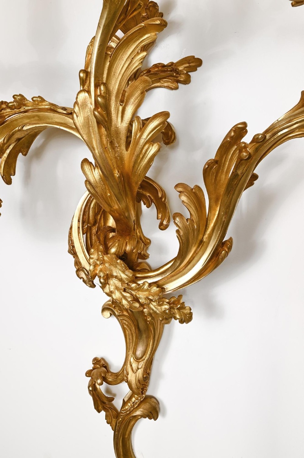 A pair of 19th-century French Rococo three-branch wall lights crafted from gilded bronze with asymmetrical acanthus leaf scrollwork. View II