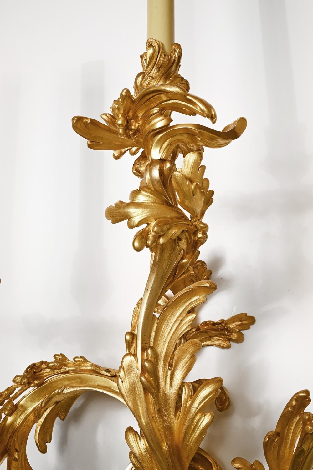 A pair of 19th-century French Rococo three-branch wall lights crafted from gilded bronze with asymmetrical acanthus leaf scrollwork. View III
