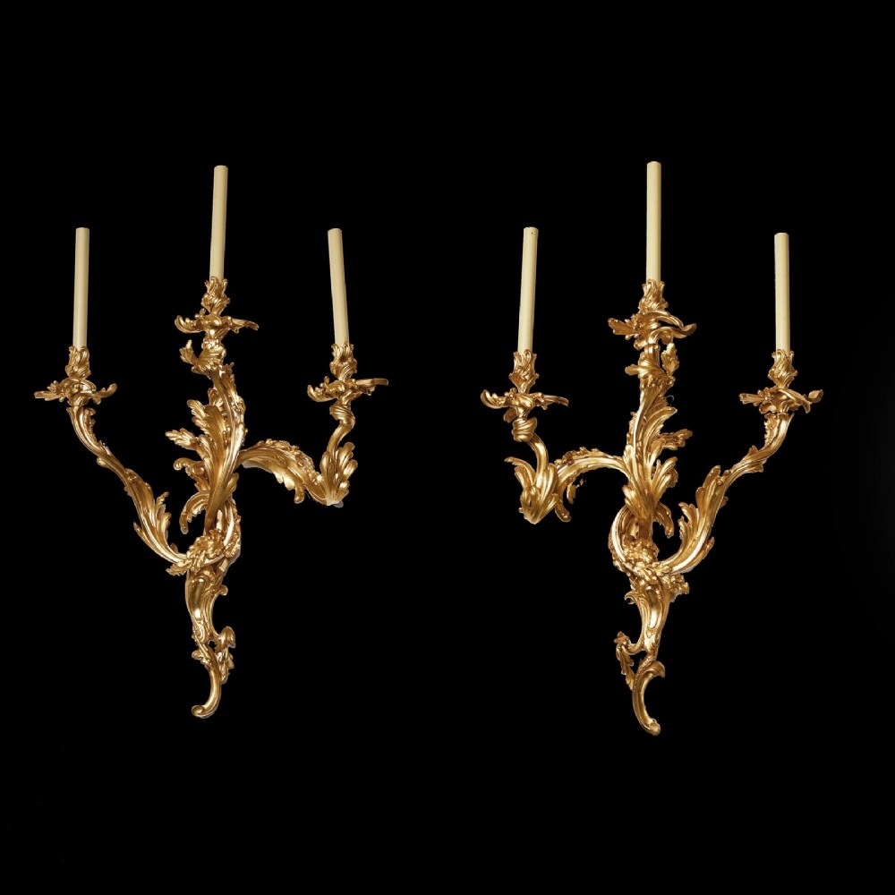 A pair of 19th-century French Rococo three-branch wall lights crafted from gilded bronze with asymmetrical acanthus leaf scrollwork. View VI