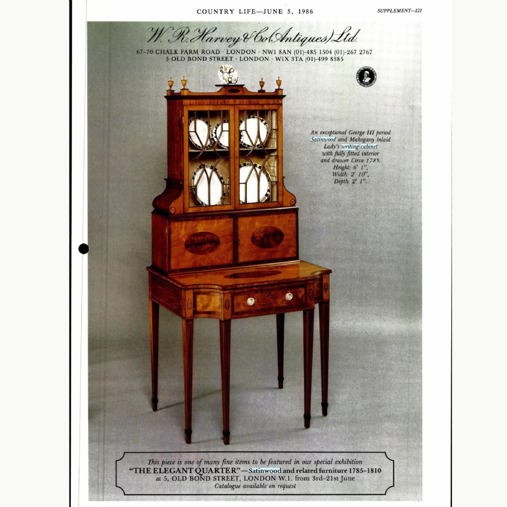 An 18th-century George III satinwood writing cabinet featuring an astragal-glazed upper section, oval marquetry inlays, and square tapered legs. View XI