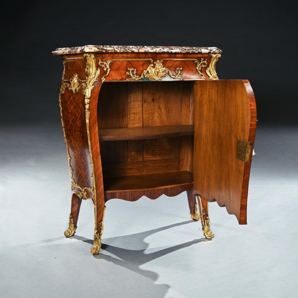 A pair of 19th-century French Louis XV style bombee kingwood petit commodes featuring hand-painted Vernis Martin panels, gilt-bronze mounts, and marble tops. View X