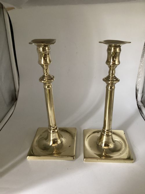 Pair of 18th century square based brass candlesticks