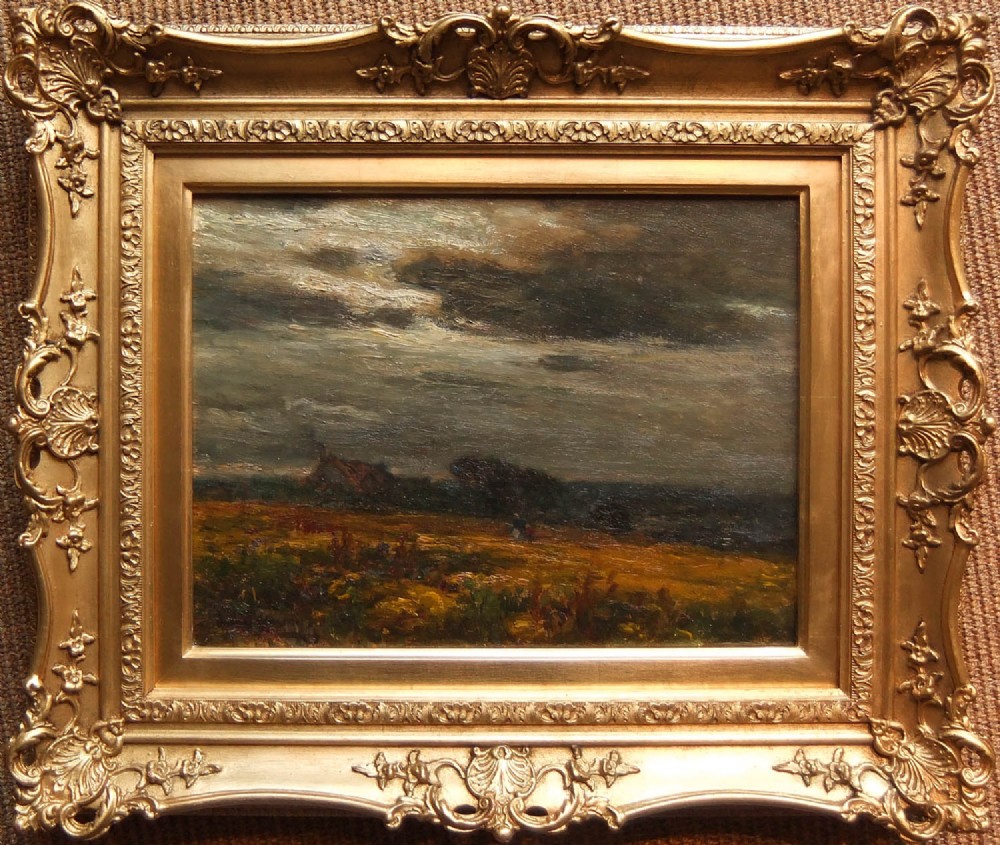 An oil painting on canvas depicting a field at dusk under a cloudy sky, set within a heavily carved gilt swept frame.