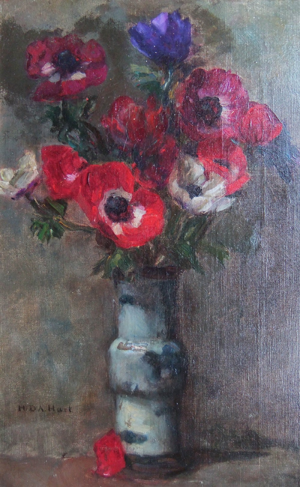 An oil painting on canvas depicting red, purple, and white anemones arranged in a tall ceramic vase against a muted background, signed H D A Hart in the lower left corner.