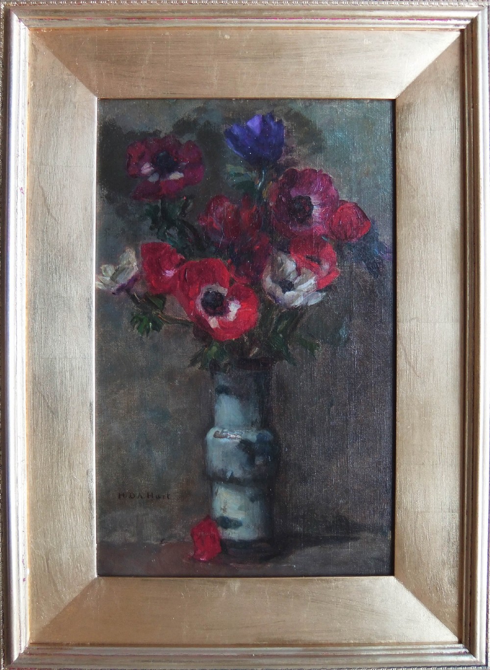 An oil painting on canvas depicting red, purple, and white anemones arranged in a tall ceramic vase against a muted background, signed H D A Hart in the lower left corner. View II
