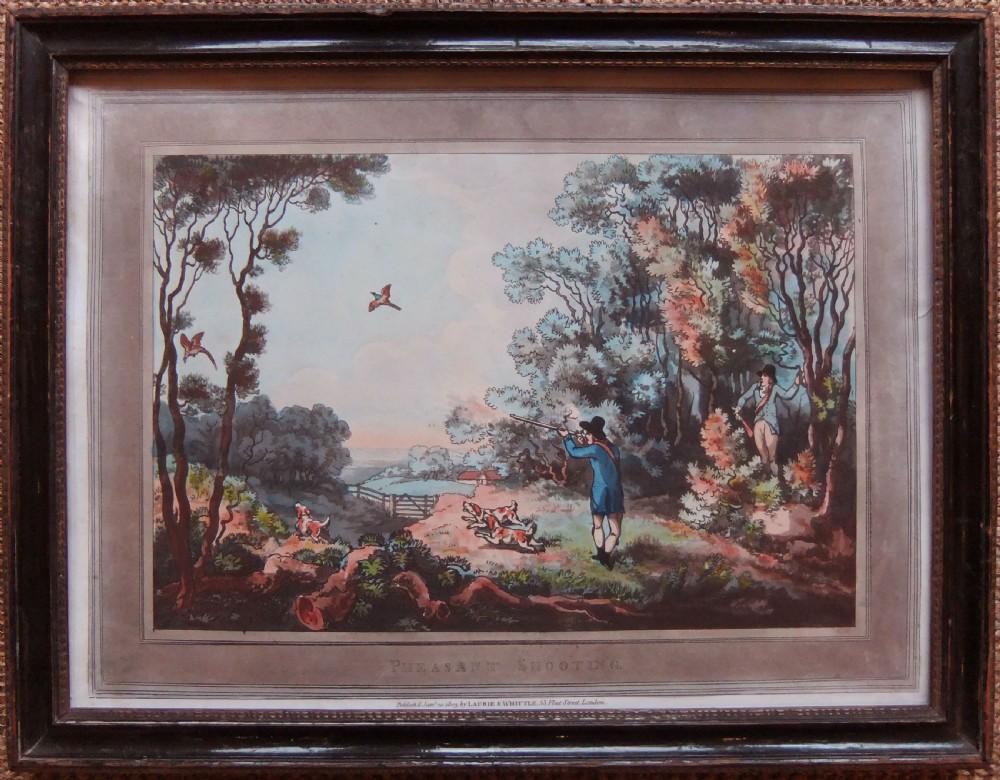 A pair of framed Georgian sporting prints depicting figures with guns and working dogs in open landscapes, housed within dark wood frames. View III