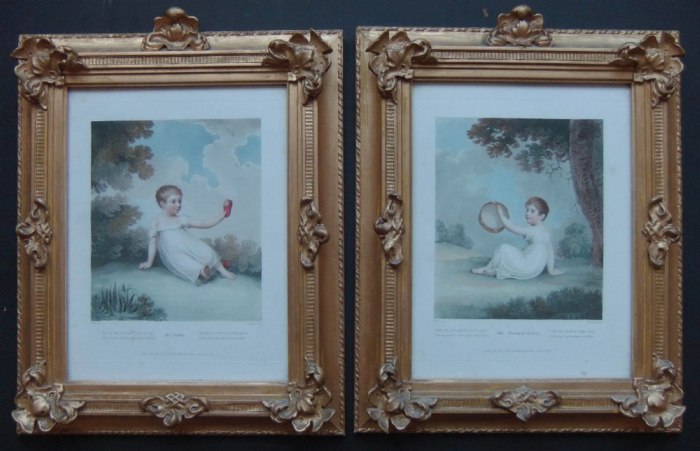 A pair of Regency coloured engravings depicting young children in white dresses, presented in matching ornate giltwood frames.