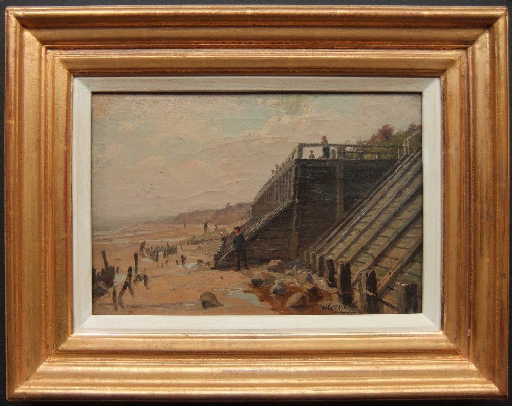 An antique coastal landscape oil painting depicting figures walking along a sandy beach near wooden sea defences and an elevated promenade under a hazy sky, signed by W. Greaves. View II