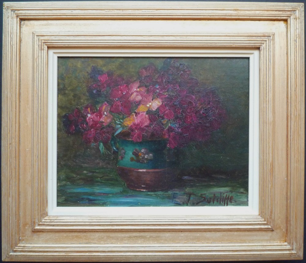 An antique oil painting depicting vibrant magenta flowers arranged in a green ceramic jar against a dark background, signed E. T. Sutcliffe. View II